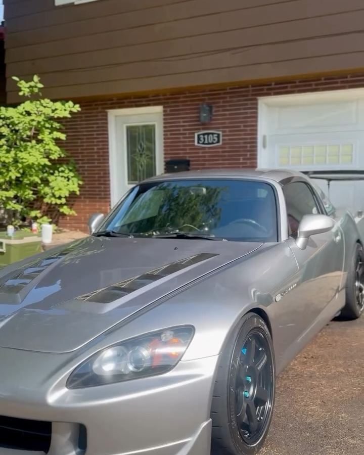 Silver Honda S2000 roadster in a driveway after a full detail
